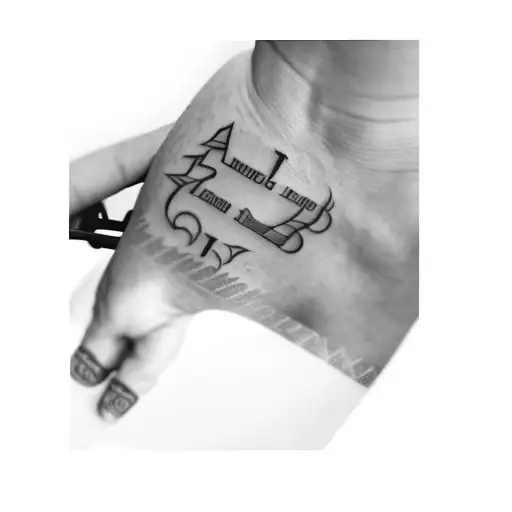 A Tattoo Of A Person's Name And Date Of Birth