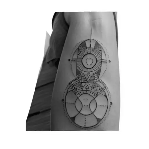 A Tattoo Of A Circle On A Person's Forearm