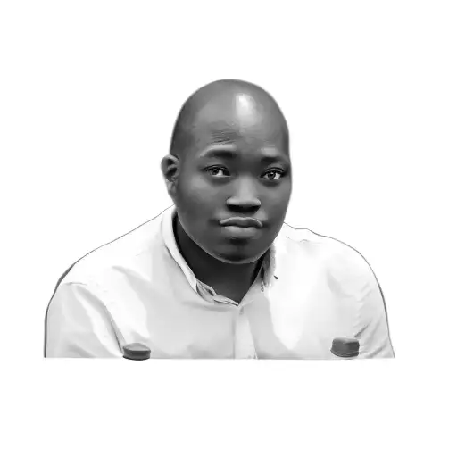 A Man Sitting At A Table With A Bottle Of Water