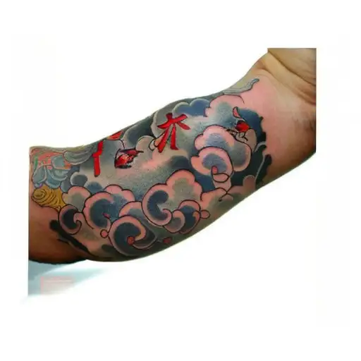 A Man With Japanese Cloud Tattoos On His Arm With Tiny Red Cardinals Mixed In